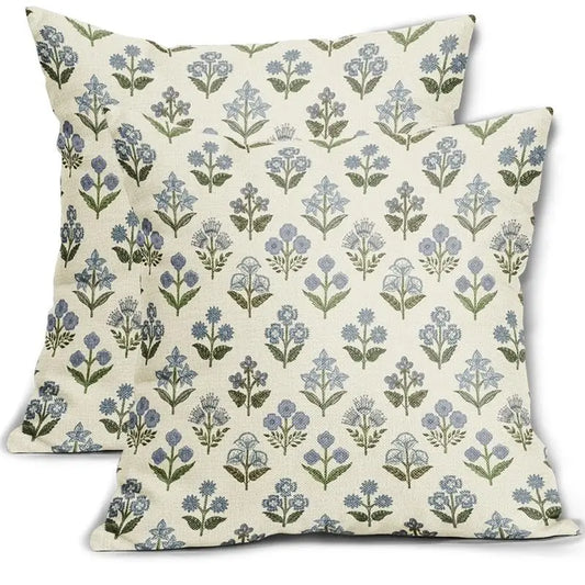 Two floral-patterned pillows on a white background