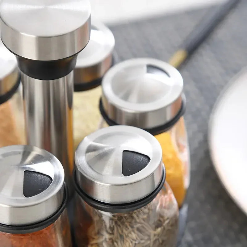 Set of spice jars with metal lids on a kitchen counter