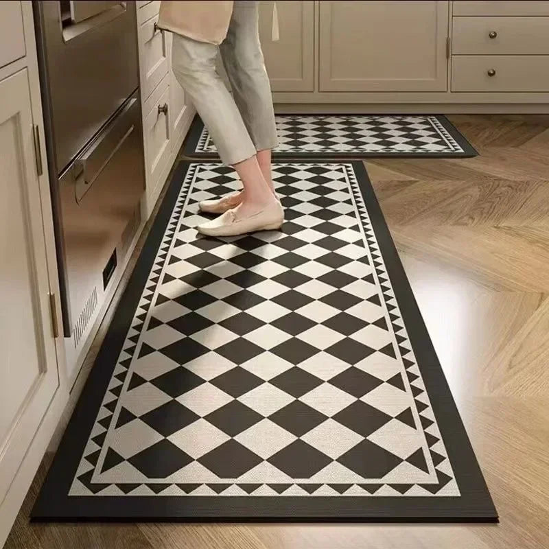 Person walking on a black and white checkered rug in a kitchen.