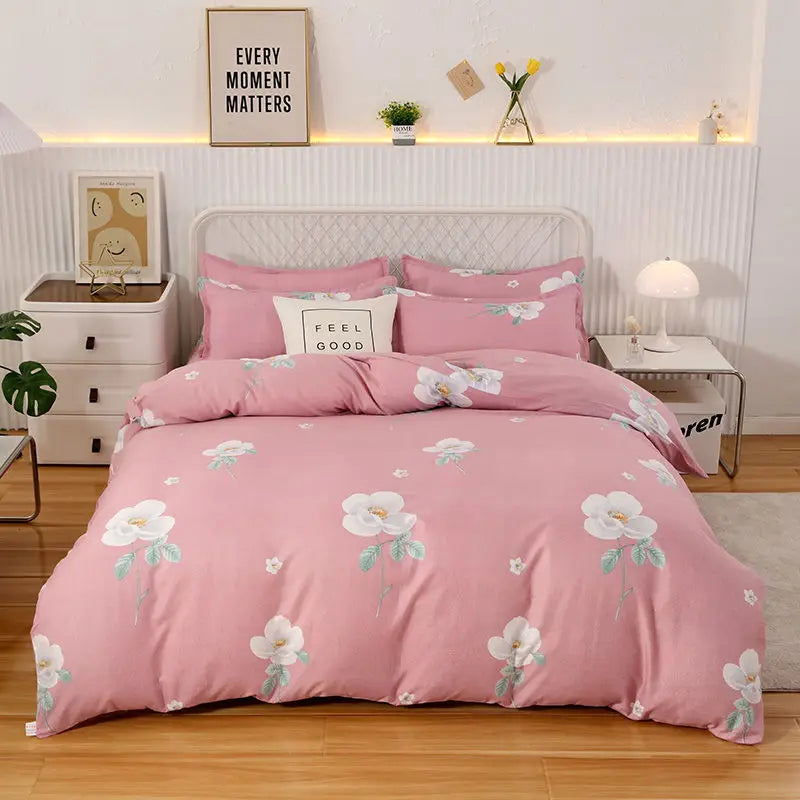 Pink floral bedding set on a bed in a bedroom setting with decor elements.