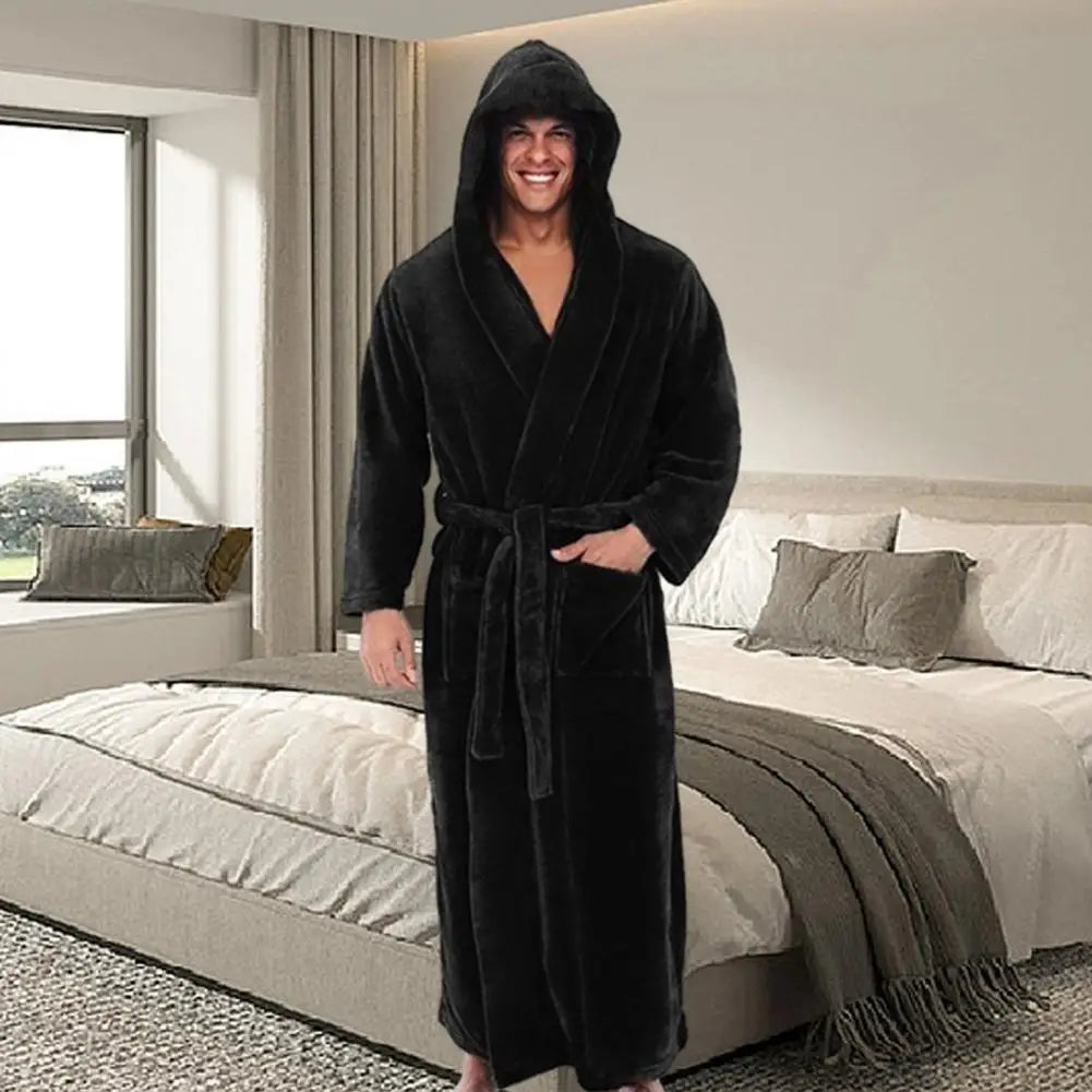 Man wearing a black robe in a bedroom setting