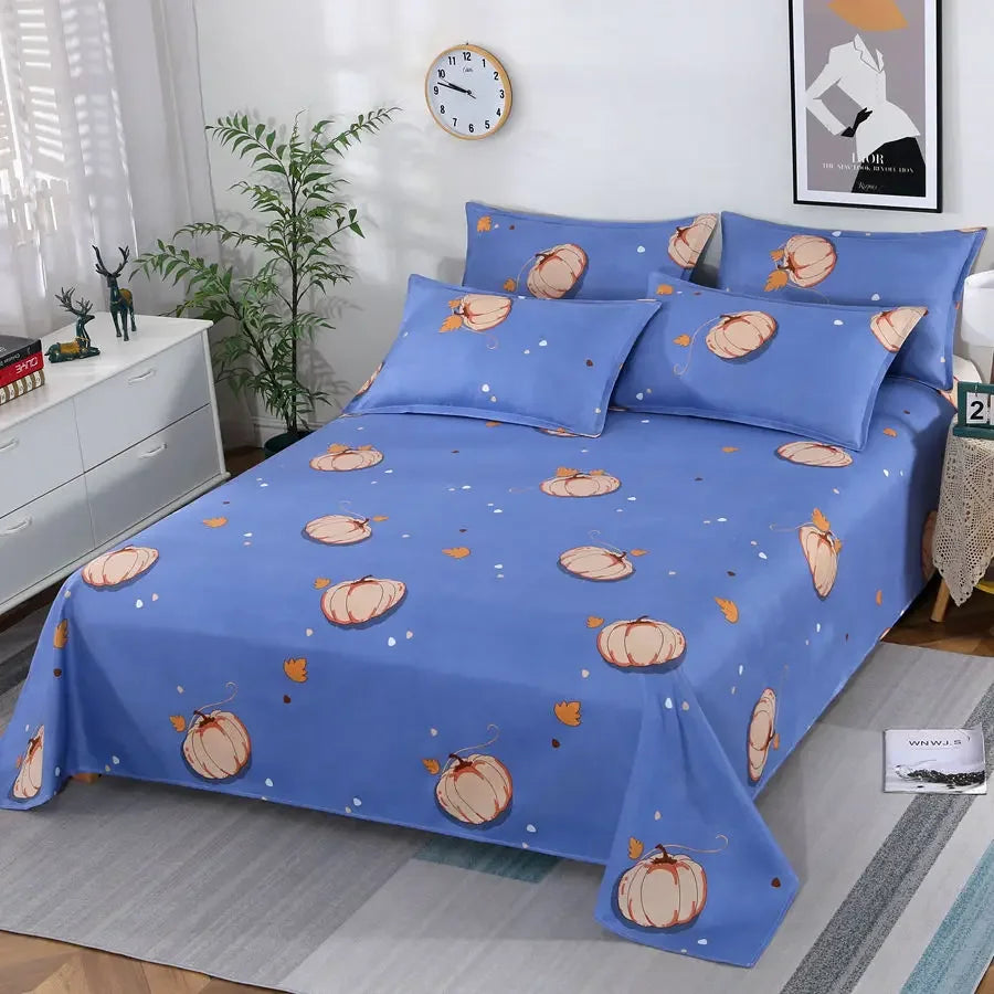 Blue bedspread with pumpkin pattern on a bed in a room setting.