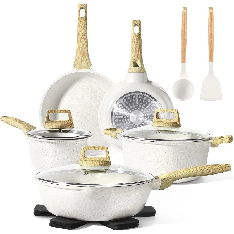 Set of white cookware with gold handles on a white background