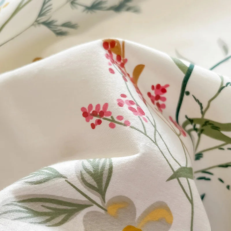 Close-up of fabric with floral and leaf patterns on a white background