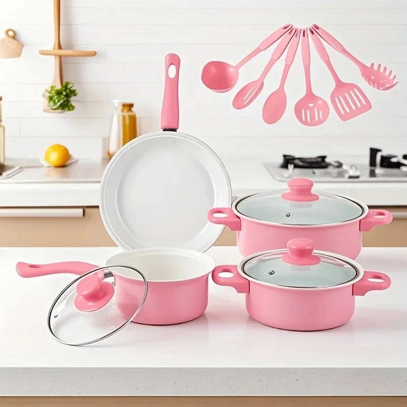 Set of pink cookware with lids on a kitchen counter, including pots, pans, and measuring spoons.