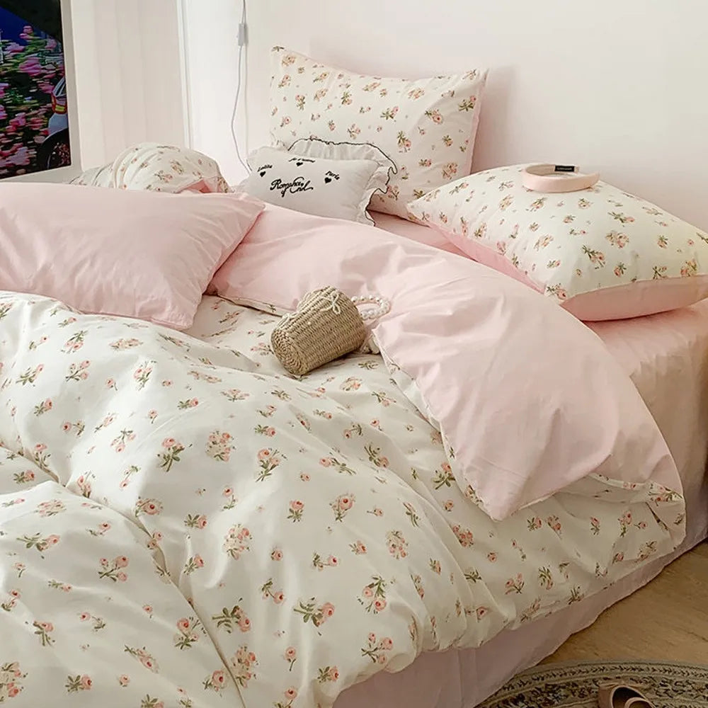 Floral bedding set on a bed with matching pillows.